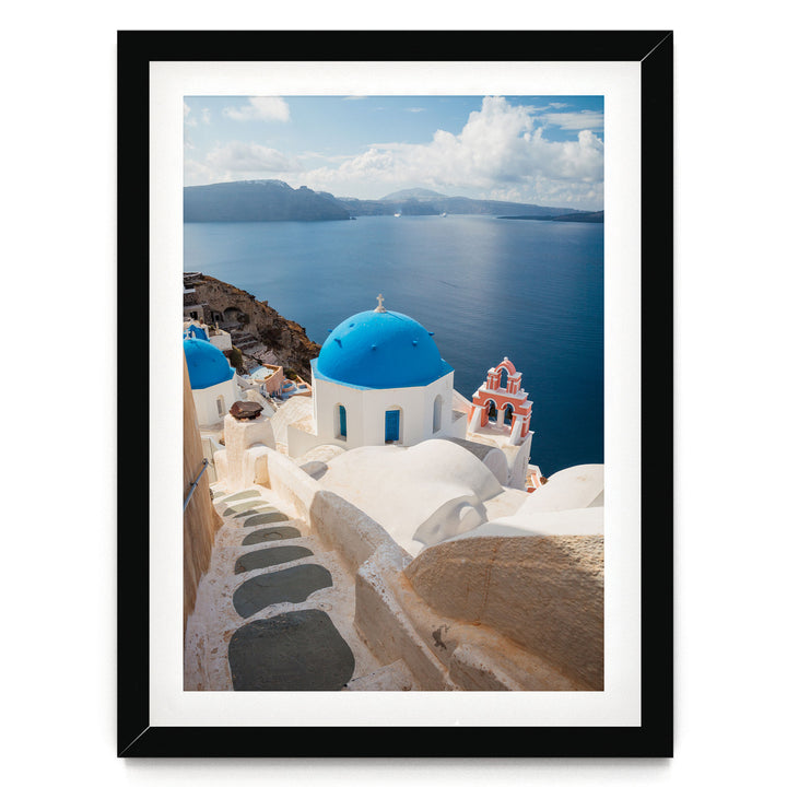 a picturesque view of the iconic blue domes and white buildings of Santorini, Greece, overlooking the stunning blue waters of the Aegean Sea.