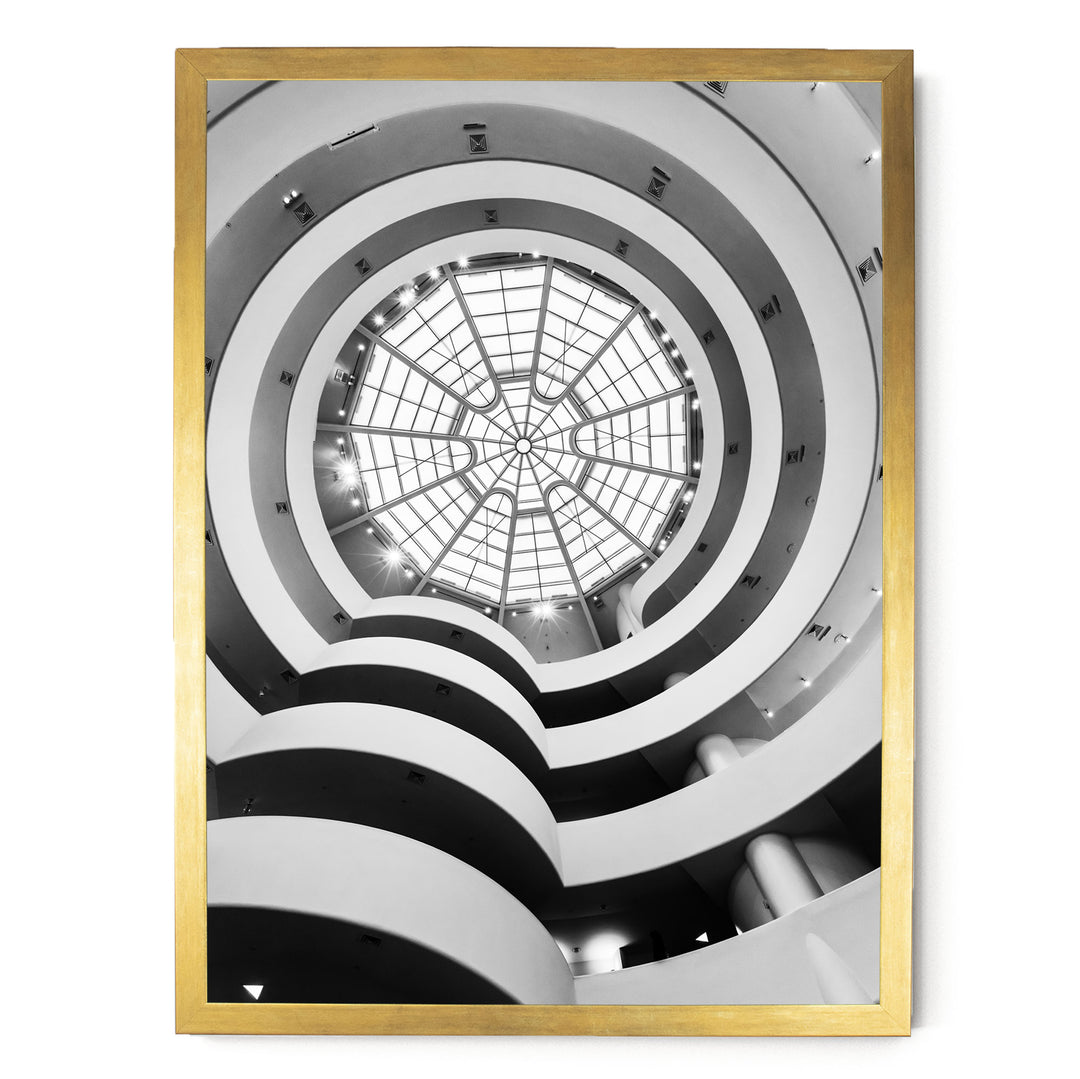 a large, circular glass dome with a skylight at the top, situated within a building with multiple levels and curved walls.
