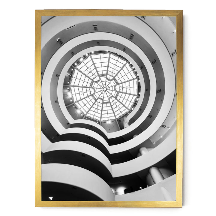 a large, circular glass dome with a skylight at the top, situated within a building with multiple levels and curved walls.