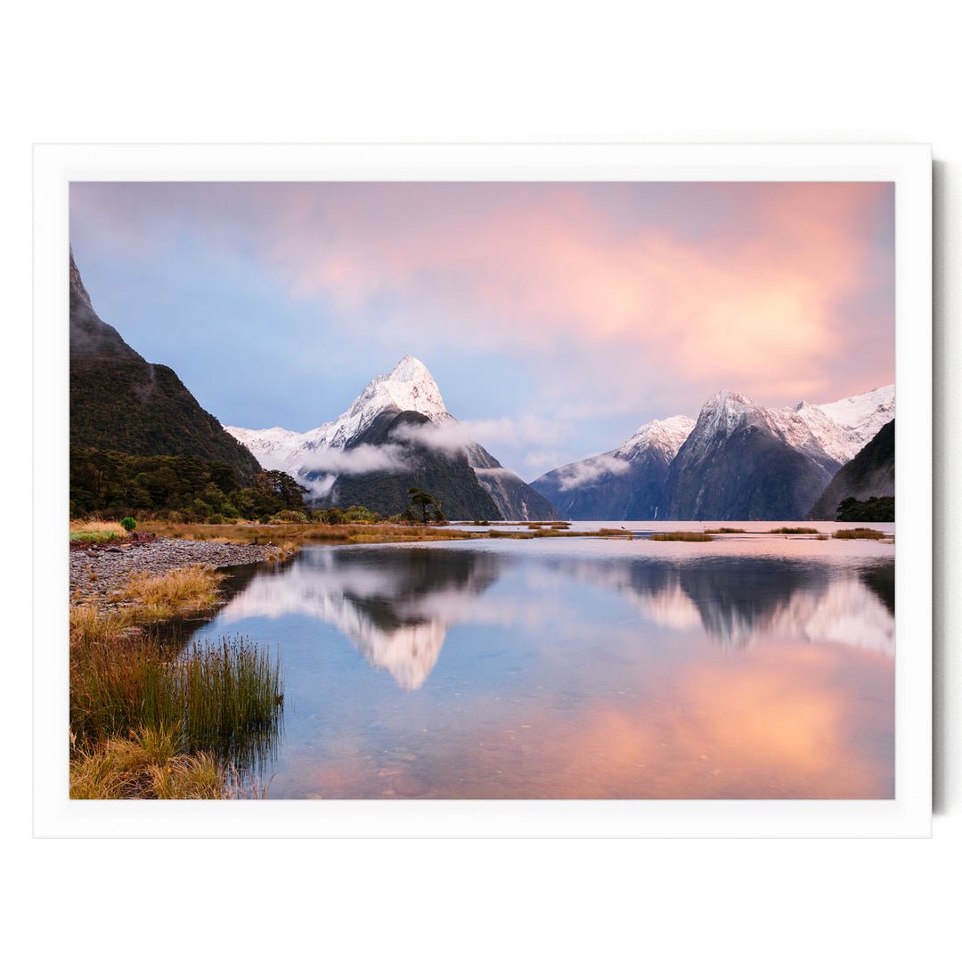 a serene landscape with a mountain range reflected in a calm lake, surrounded by lush vegetation and a vibrant sky.