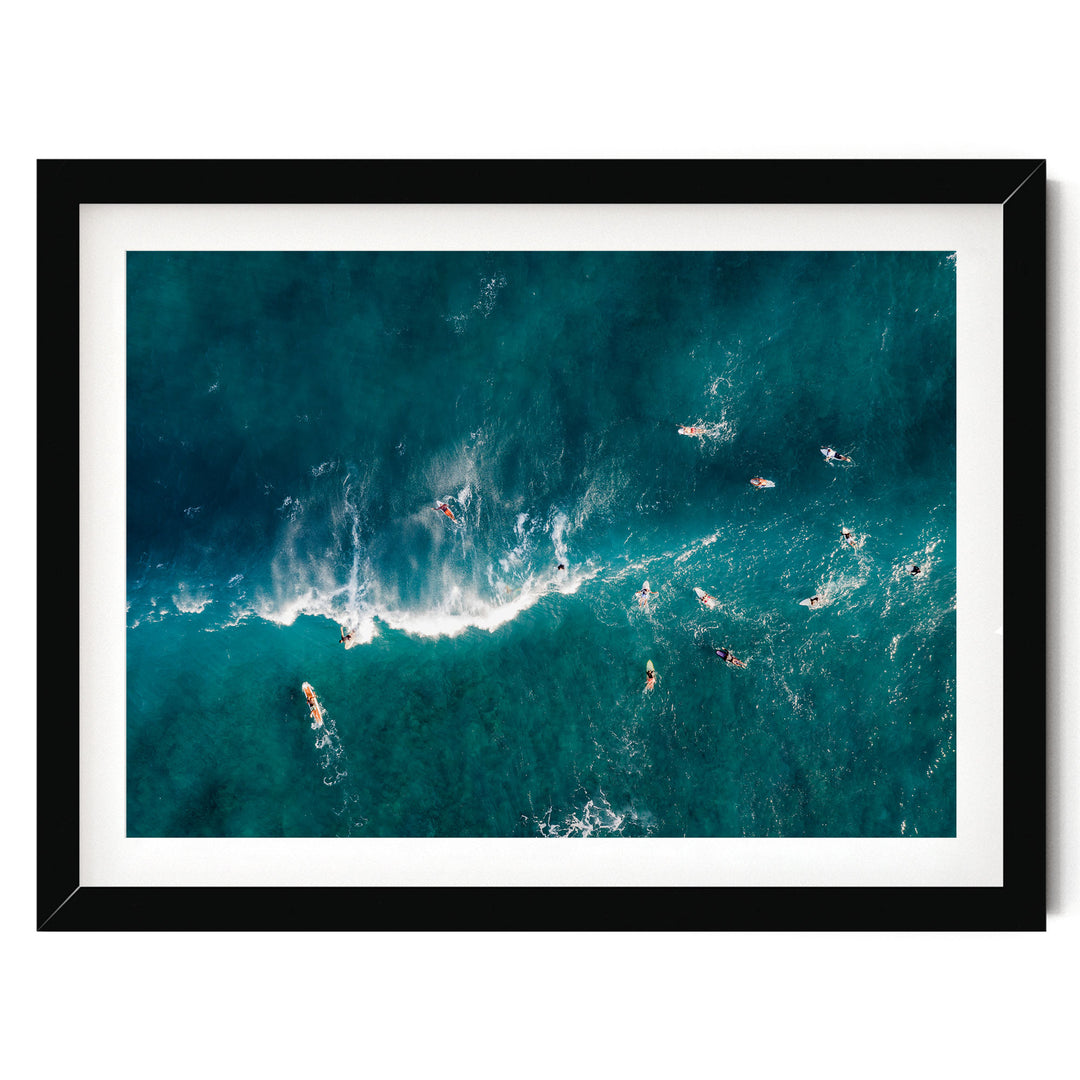 a group of people surfing in the ocean, with waves crashing around them.