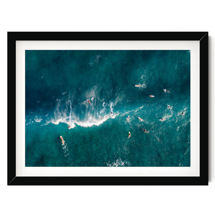 a group of people surfing in the ocean, with waves crashing around them.
