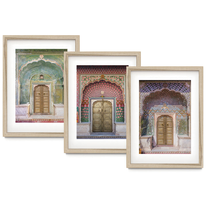 three framed paintings of doors in a building