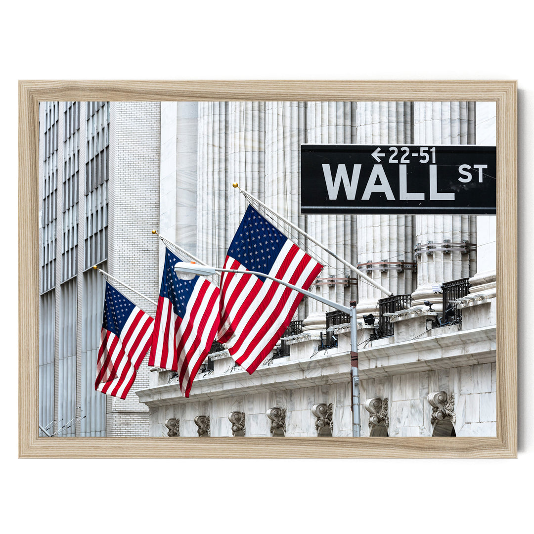 three American flags flying in front of a building with the sign "Wall Street" displayed.