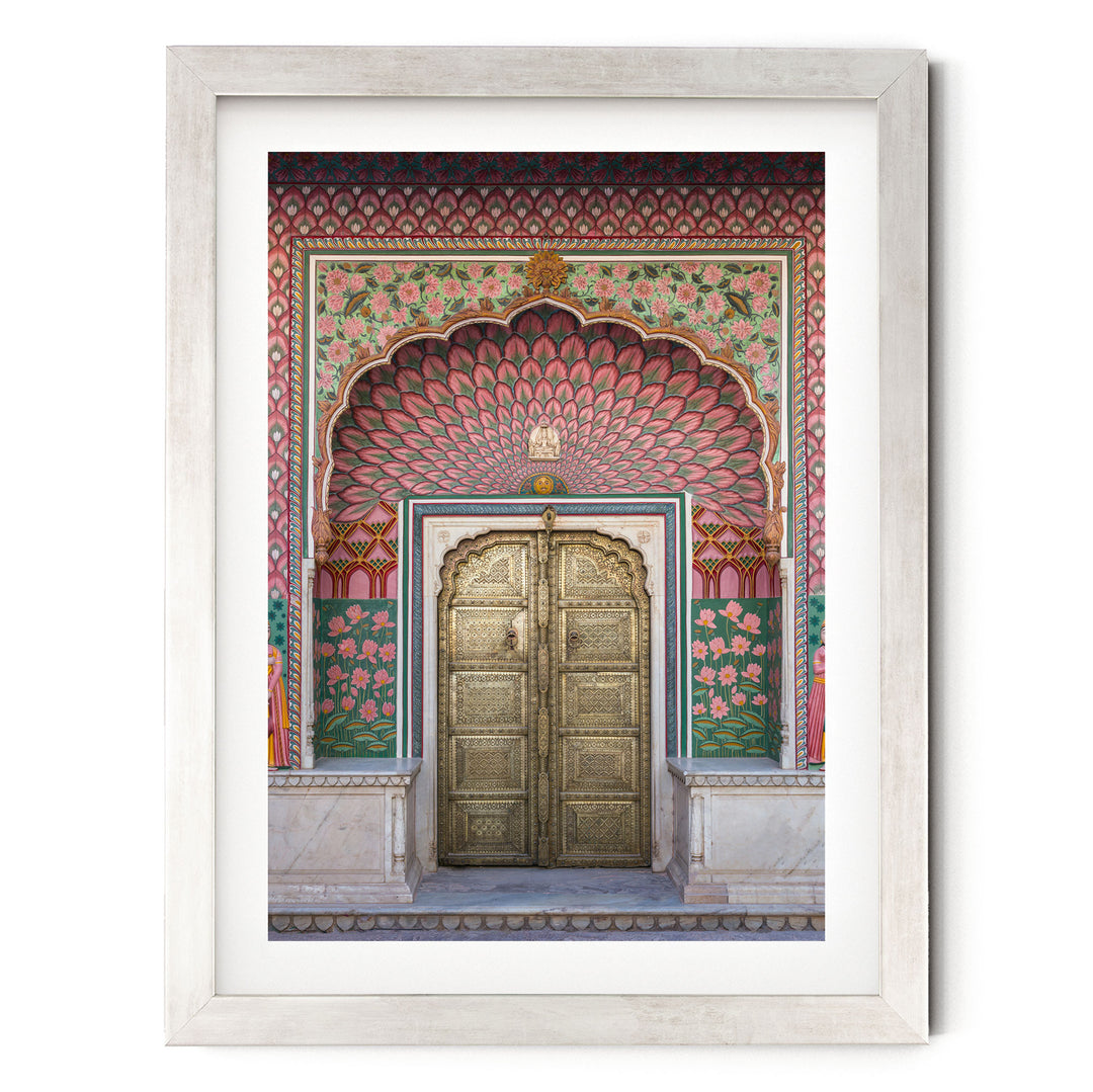 a large, ornate golden door with intricate designs and patterns, set within a colorful, decorative archway.