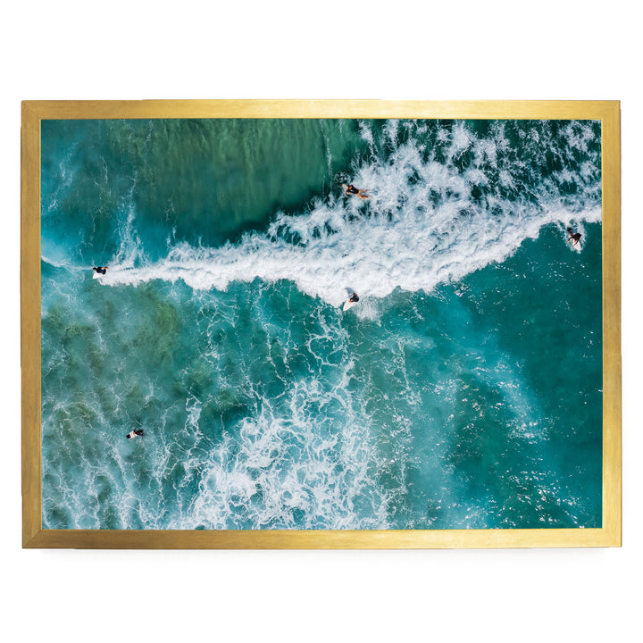 a group of people surfing on a large, turquoise wave in the ocean.