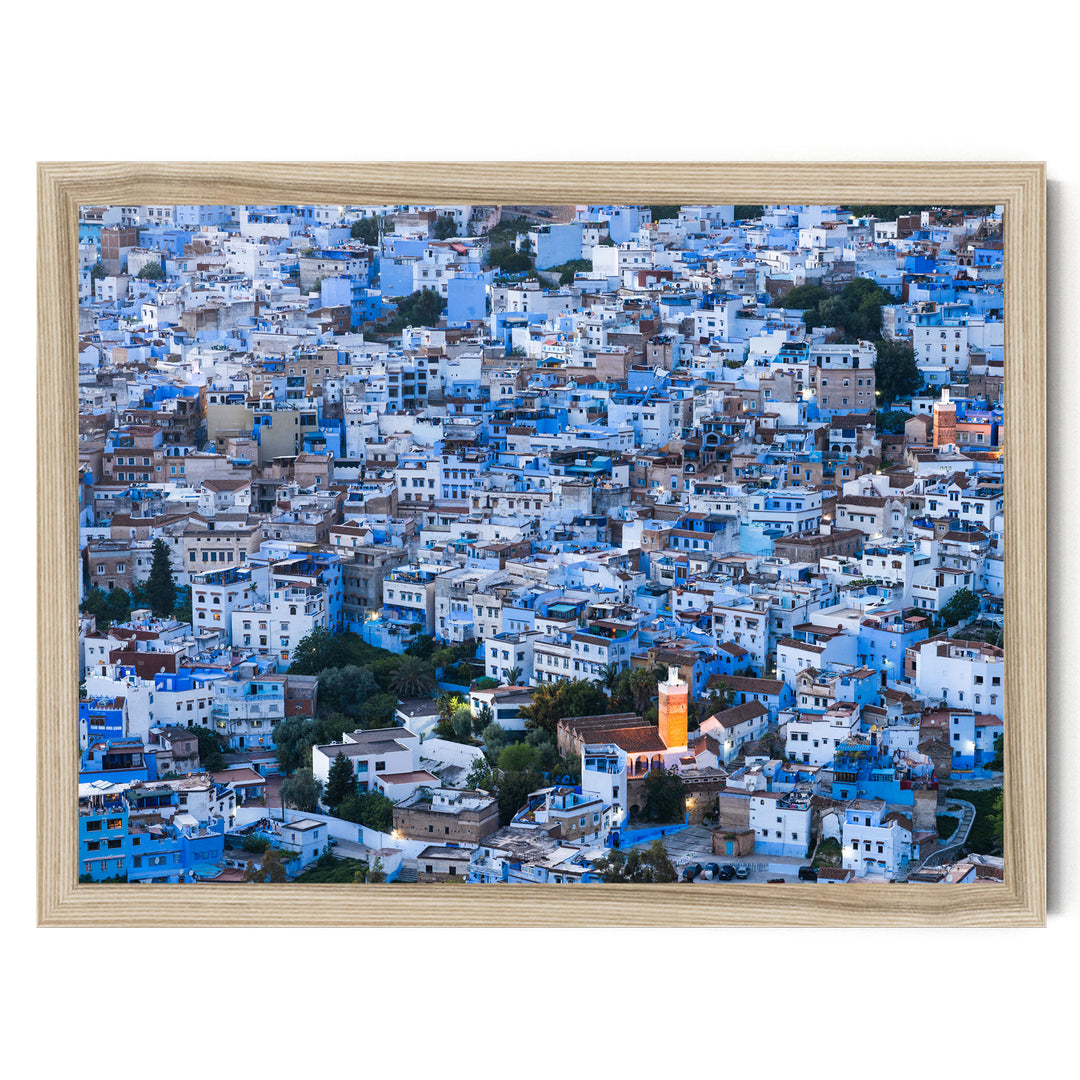 The image is a densely packed cityscape with numerous buildings painted in shades of blue and white, creating a visually striking and vibrant scene.