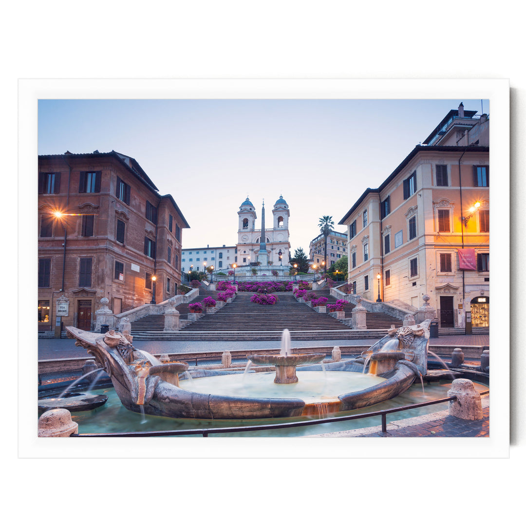 a picturesque scene of a fountain situated in a city square, with a church steeple visible in the background.