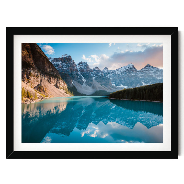 A breathtaking landscape featuring a serene lake surrounded by majestic snow-capped mountains, with the mountains' peaks reflected perfectly in the calm waters.