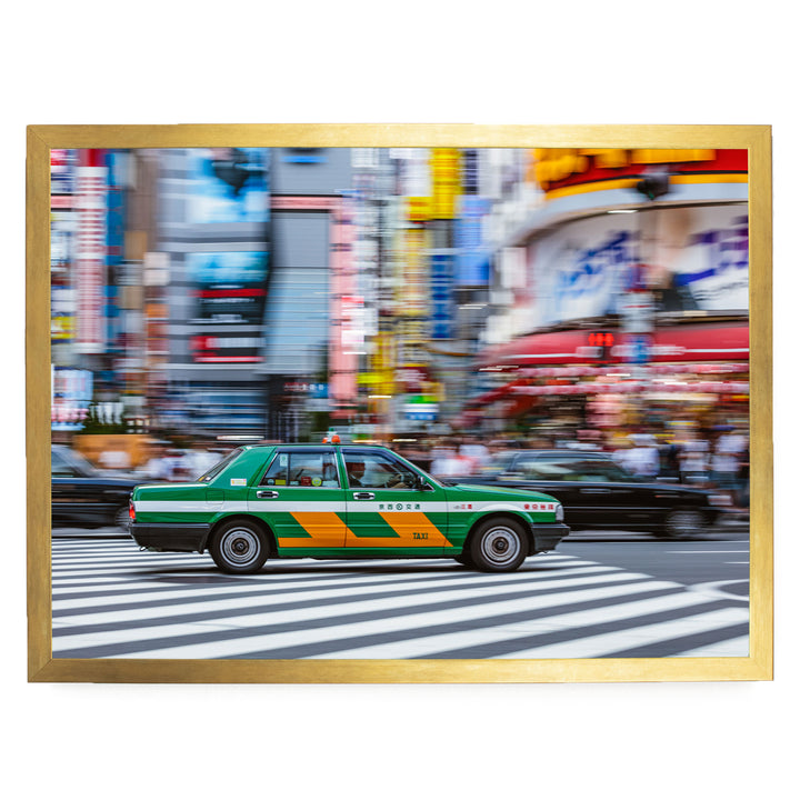 A green taxi cab is driving through a busy city street, with colorful buildings and pedestrians in the background.