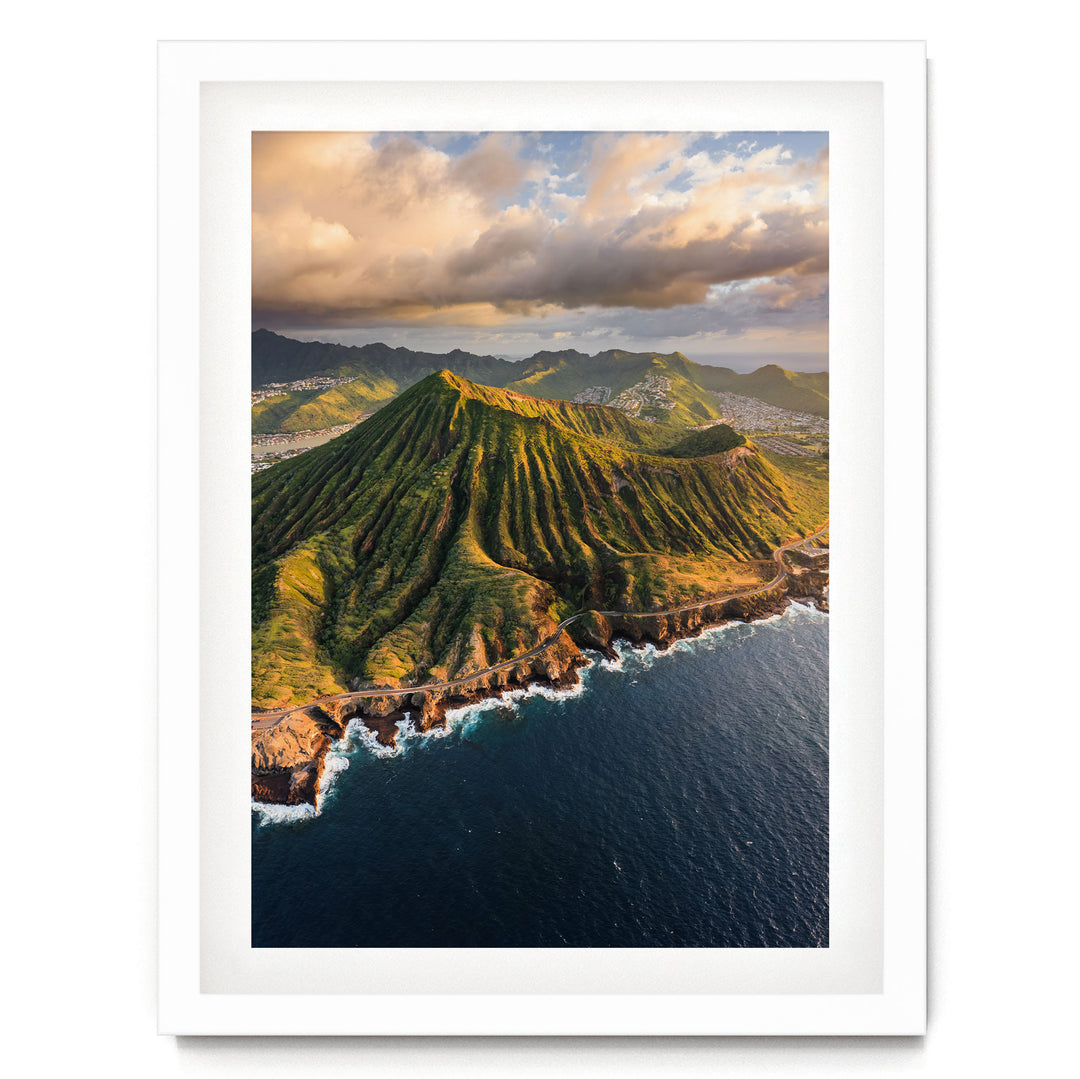 a mountainous coastline with a steep, lush green hillside overlooking the ocean.