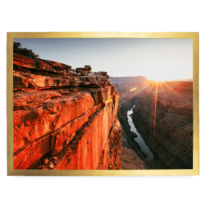 a breathtaking view of a canyon with a river flowing through it, set against a stunning sunset sky.