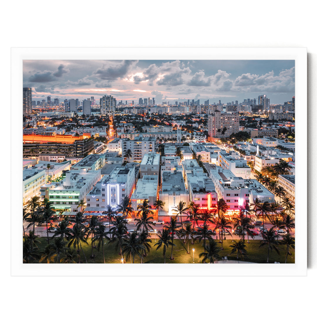 a vibrant cityscape at night, with a skyline of tall buildings and skyscrapers illuminated by colorful lights. The city is surrounded by lush palm trees, creating a striking contrast between the urban architecture and the natural environment. The scene is captured from a high vantage point, providing a comprehensive view of the city's layout and layout.