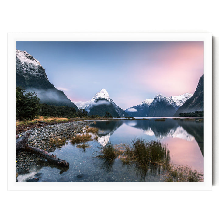 a serene mountain landscape with snow-capped peaks reflected in a calm lake, surrounded by lush vegetation and a clear blue sky.