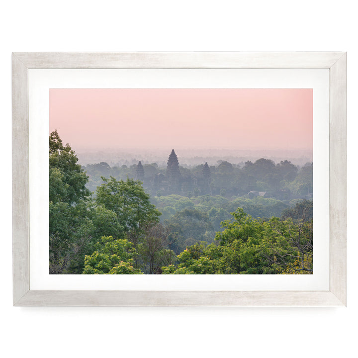 a serene landscape with a forested area and a temple in the distance, set against a hazy pink sky.