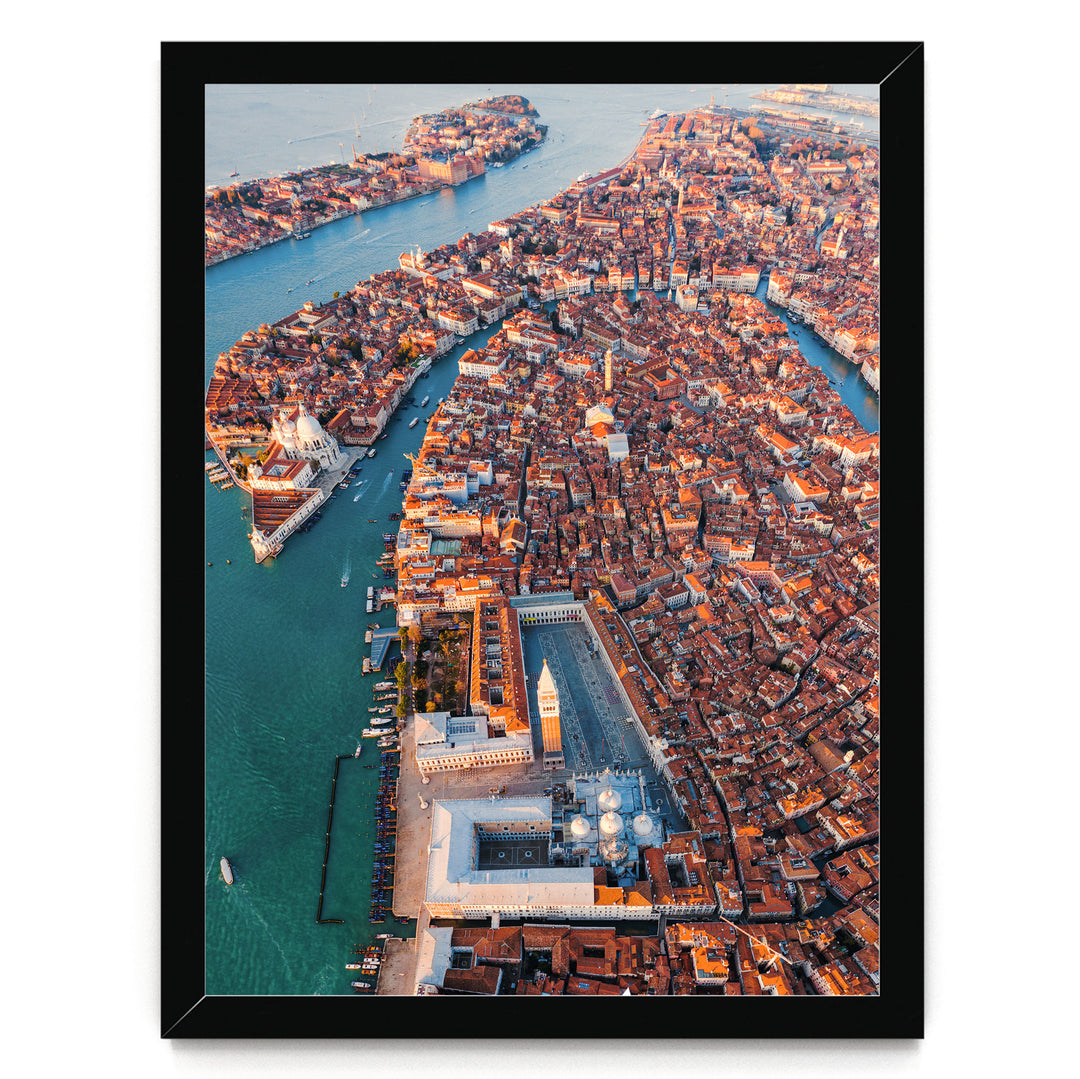 An aerial view of the city of Venice, Italy, showcasing its iconic canals, domes, and buildings.