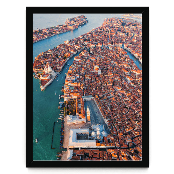 An aerial view of the city of Venice, Italy, showcasing its iconic canals, domes, and buildings.