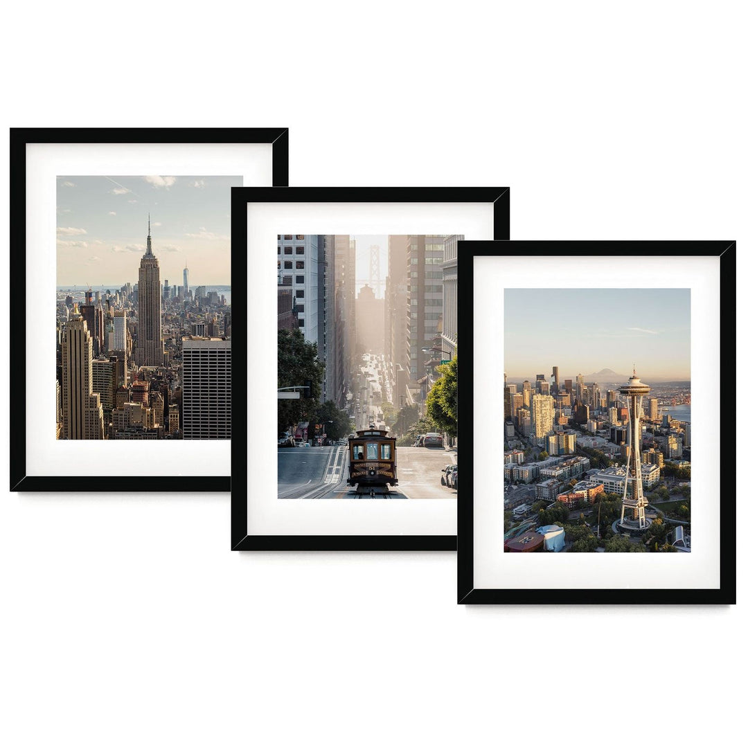 The image is a collage of three framed photographs depicting different scenes from the New York City skyline, including the Empire State Building, the Space Needle, and a trolley car.