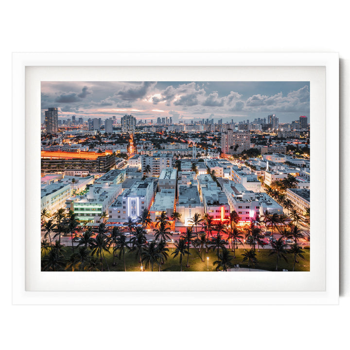a vibrant cityscape at dusk, with a mix of tall buildings, palm trees, and colorful lights illuminating the urban landscape.