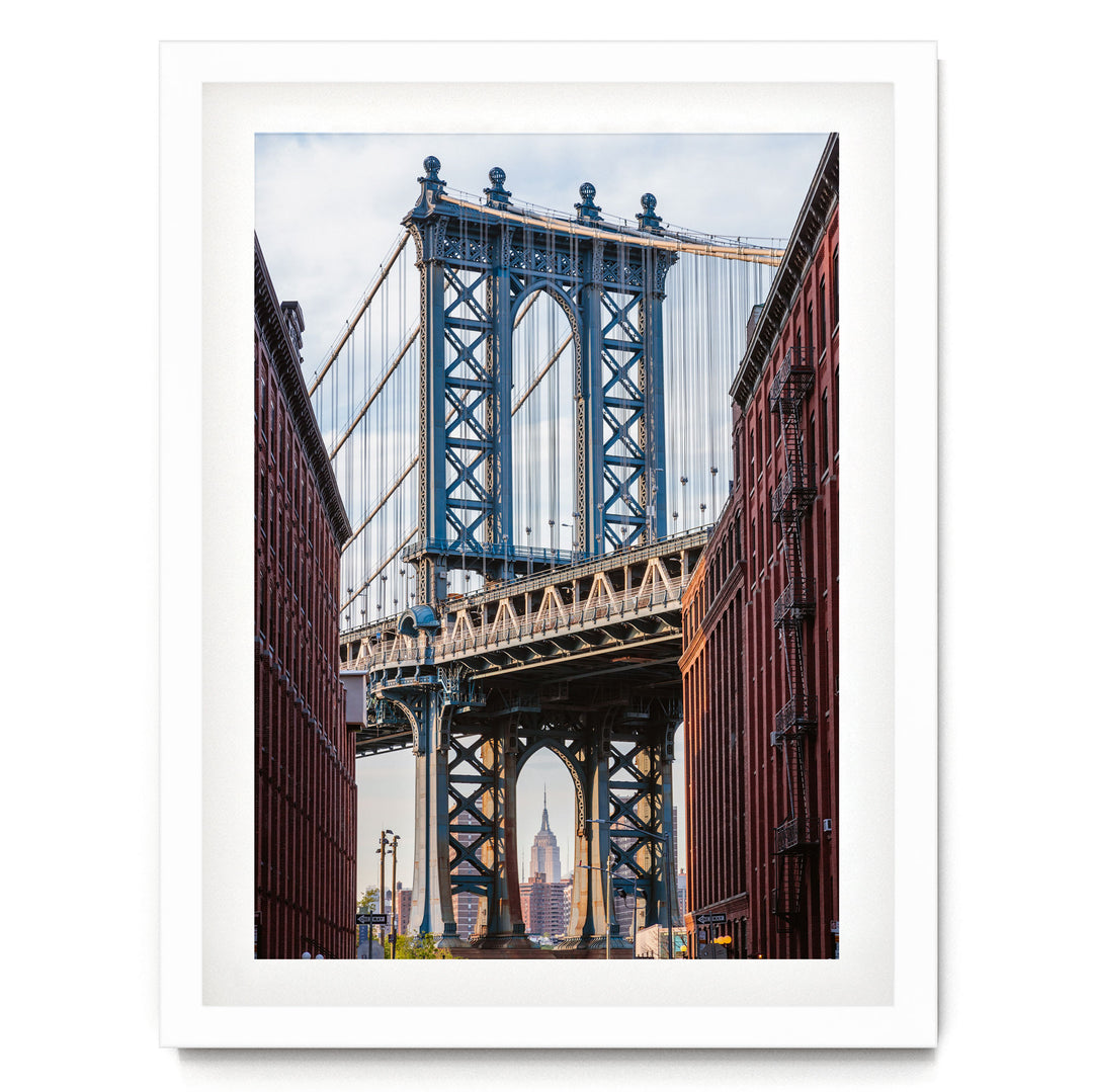 the Manhattan Bridge, a famous suspension bridge in New York City, with its distinctive blue towers and cables stretching across the frame.