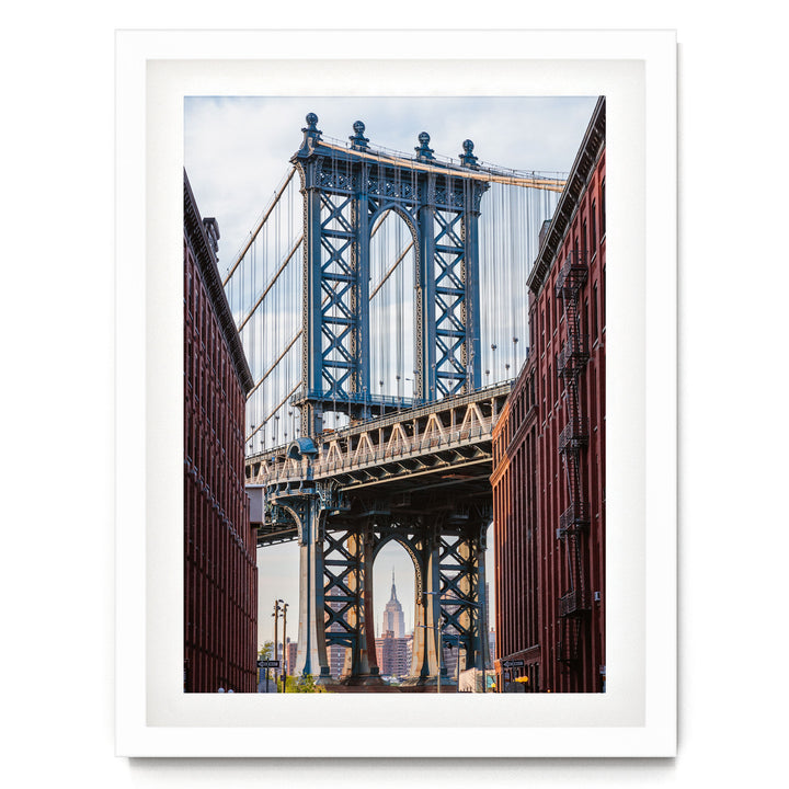 the Manhattan Bridge, a famous suspension bridge in New York City, with its distinctive blue towers and cables stretching across the frame.
