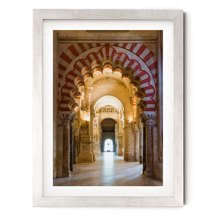 a long, ornate hallway with arched doorways and columns, creating a sense of depth and grandeur.