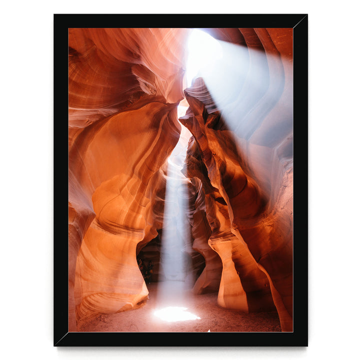 a stunning natural rock formation with a bright light shining through the narrow passage, creating a dramatic and captivating scene.