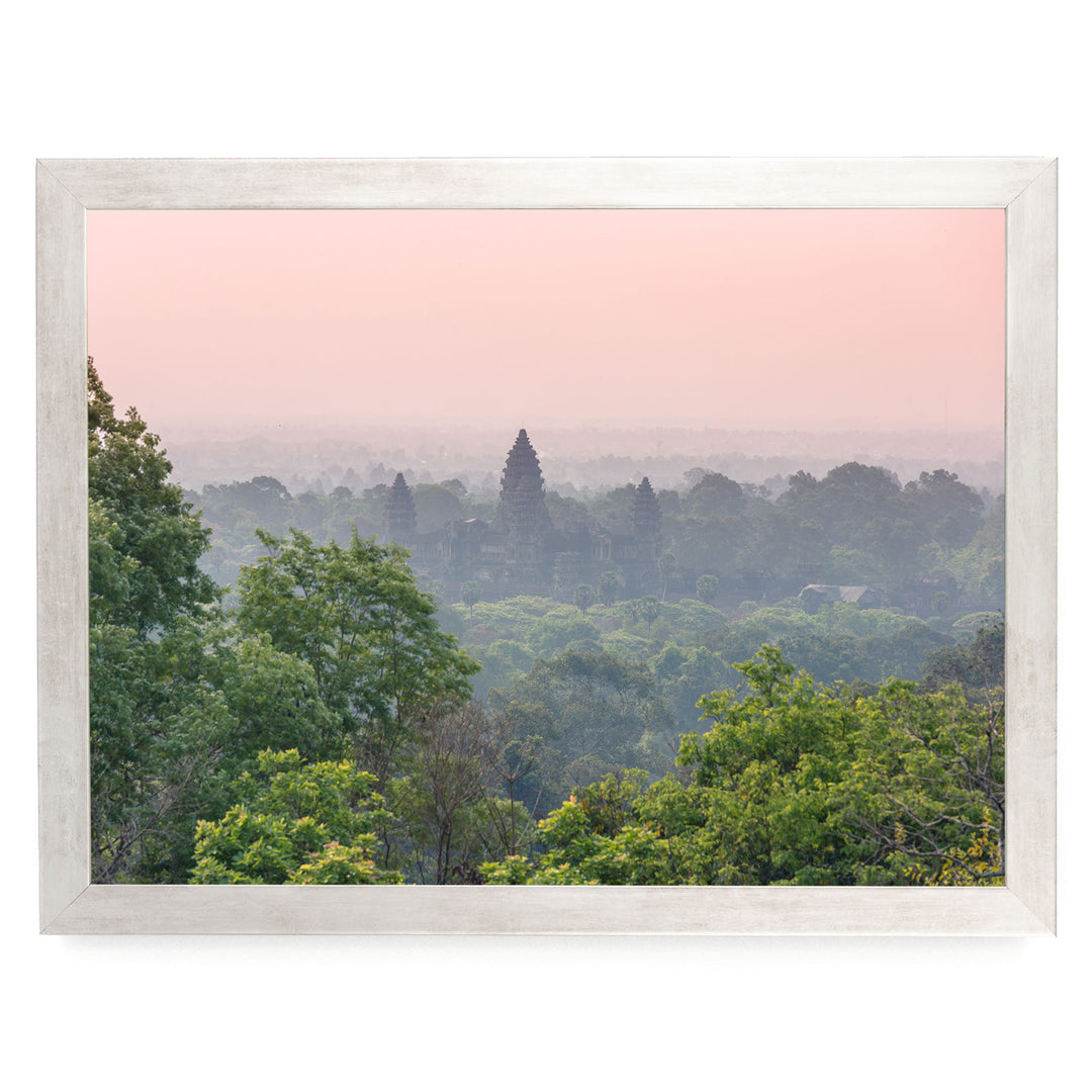 a serene landscape with a temple in the distance, surrounded by lush greenery and a hazy pink sky.