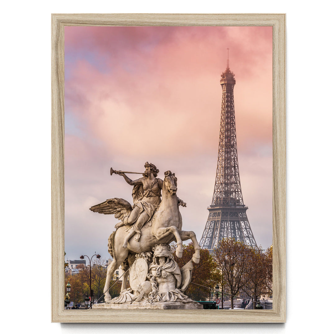 a statue of a winged horseman riding a rearing horse, with the Eiffel Tower visible in the background against a pink and purple sky.