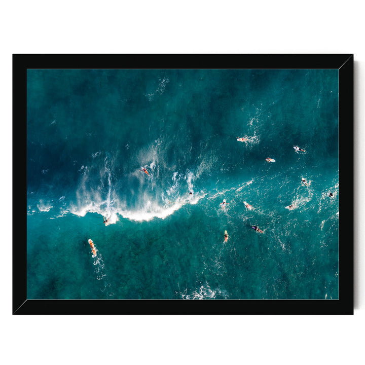a group of people surfing in the ocean, with waves crashing around them.