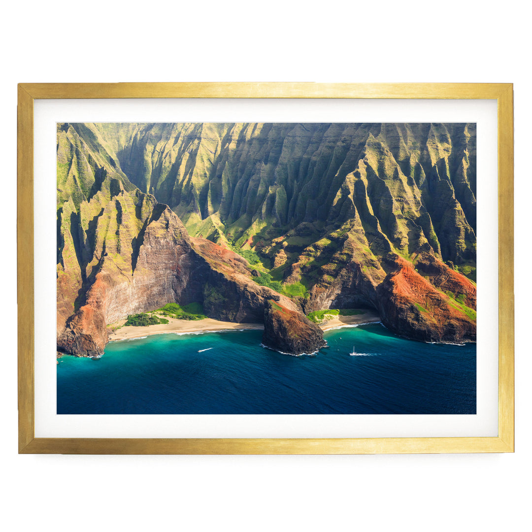 a stunning coastal landscape with towering cliffs, a deep blue ocean, and a sandy beach.