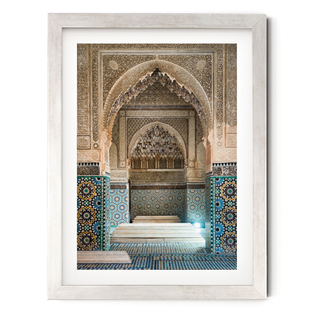 an ornate, intricately decorated interior space with a large archway and a tiled floor.