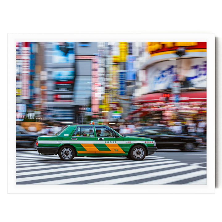 A green taxi cab is driving through a busy city street, with colorful buildings and pedestrians in the background.