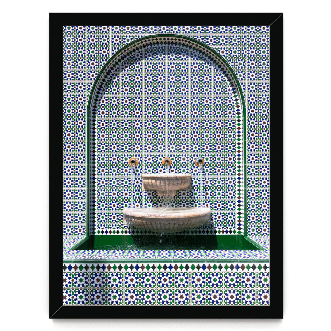 a decorative fountain with a green and white tile pattern surrounding it.