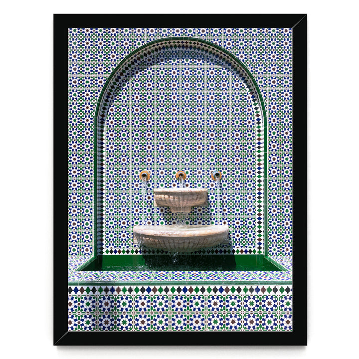 a decorative fountain with a green and white tile pattern surrounding it.