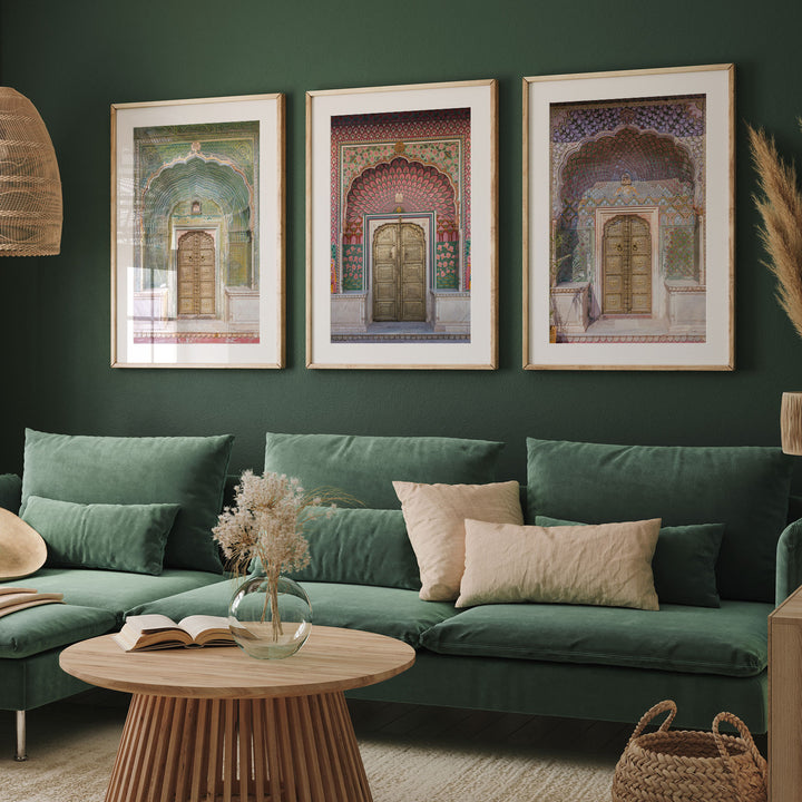 a living room with a green couch and two pictures on the wall