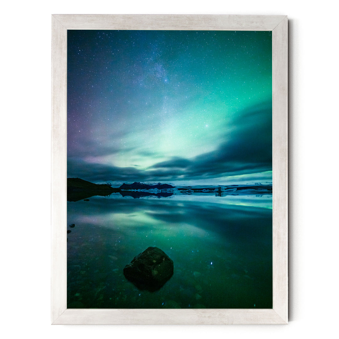 a serene night scene with a starry sky reflected in a calm body of water, creating a beautiful and tranquil atmosphere.