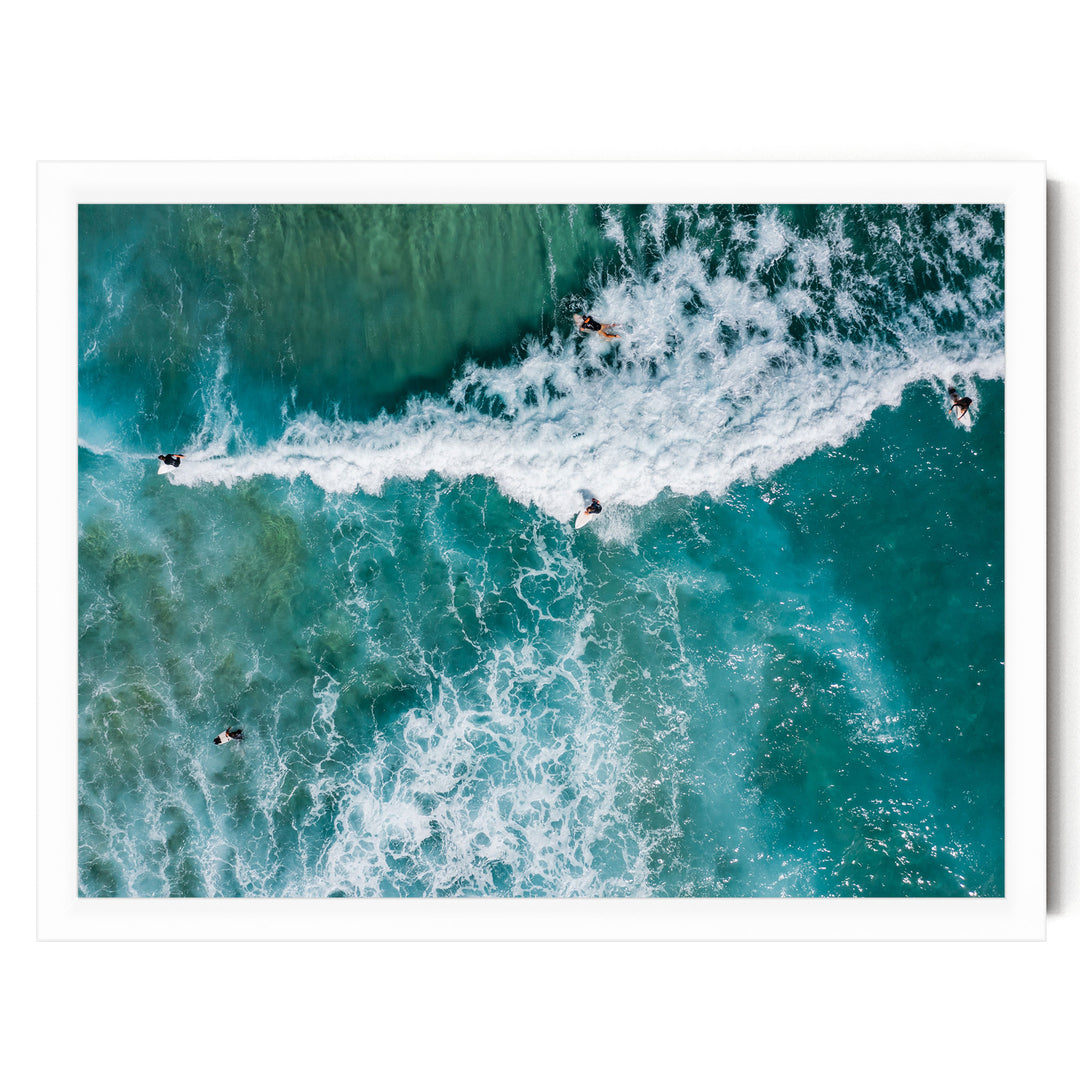 a group of people surfing on a large, turquoise wave in the ocean.