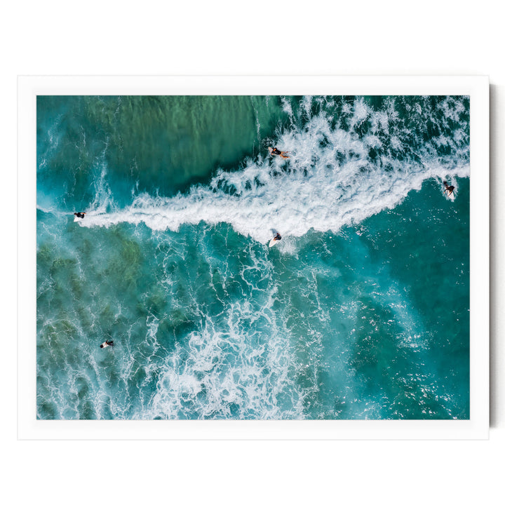 a group of people surfing on a large, turquoise wave in the ocean.