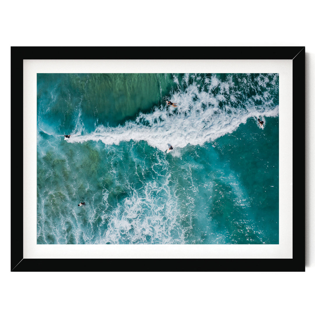 a group of people surfing on a large, foamy wave in the ocean.