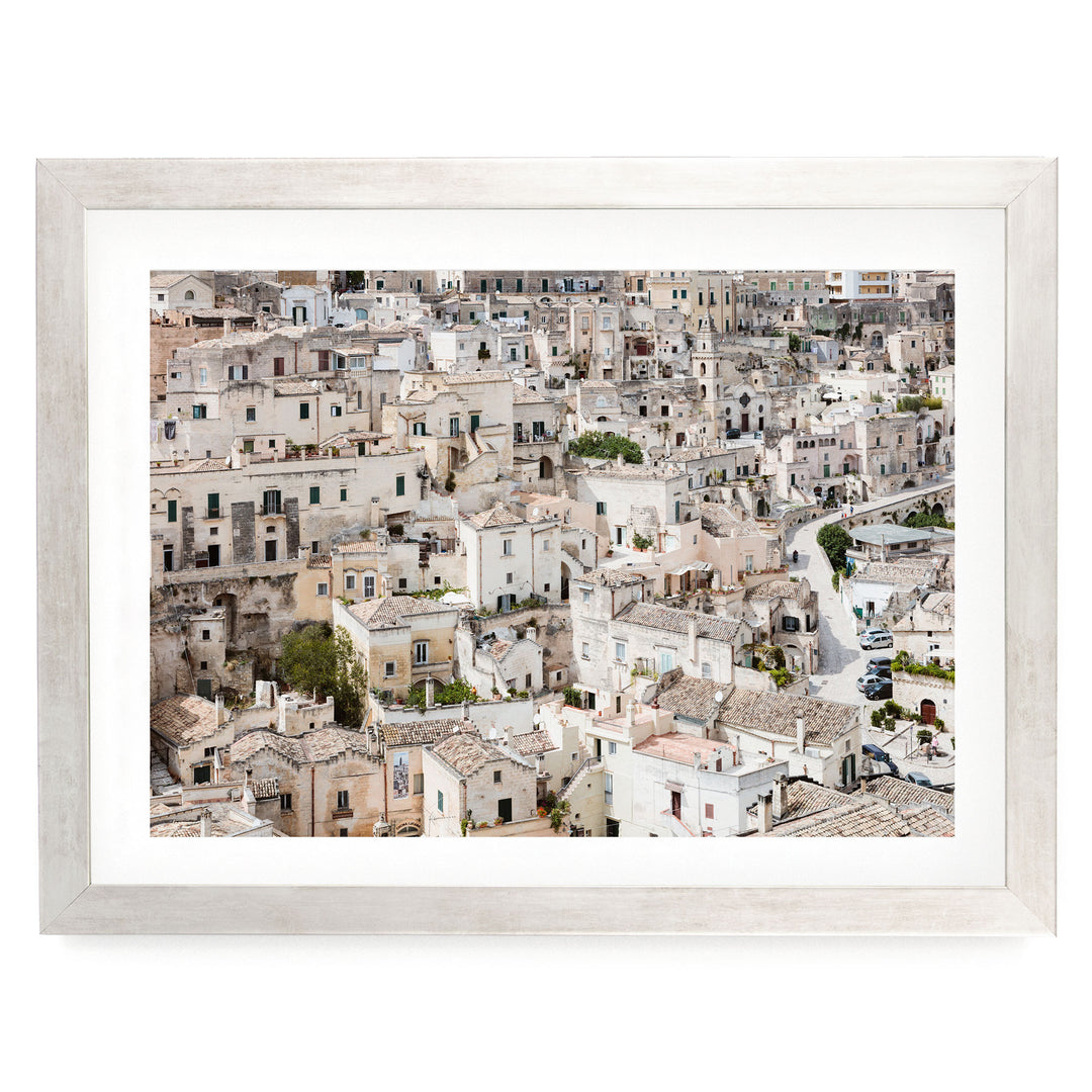 The image is a panoramic view of a densely populated city with numerous buildings and structures, showcasing the urban landscape.