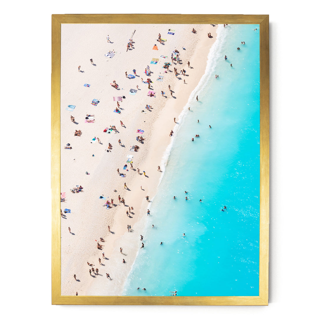 a crowded beach with people enjoying the sun and water.