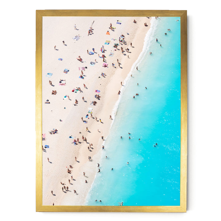 a crowded beach with people enjoying the sun and water.