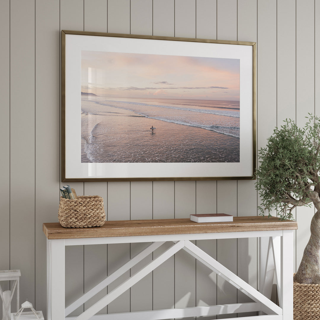 Lone Surfer on a Pink Beach II, Costa Rica framed wall art in a home interior
