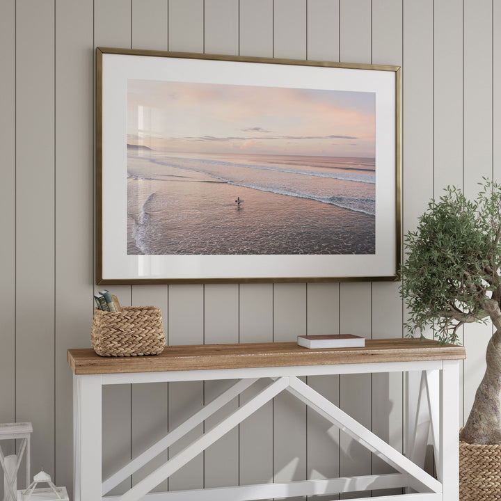 Lone Surfer on a Pink Beach II, Costa Rica framed wall art in a home interior