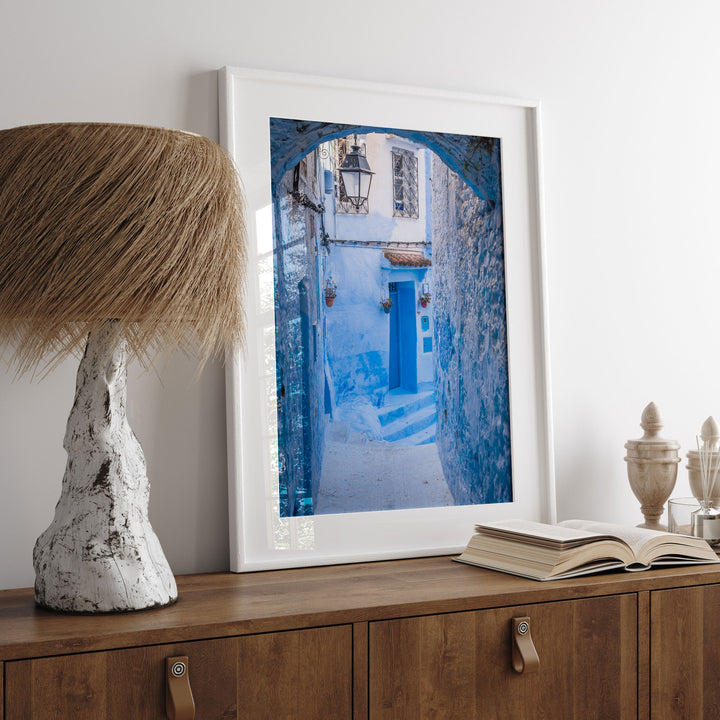 Blue Alley with Lantern, Chefchaouen, Morocco print displayed in a bedroom setting