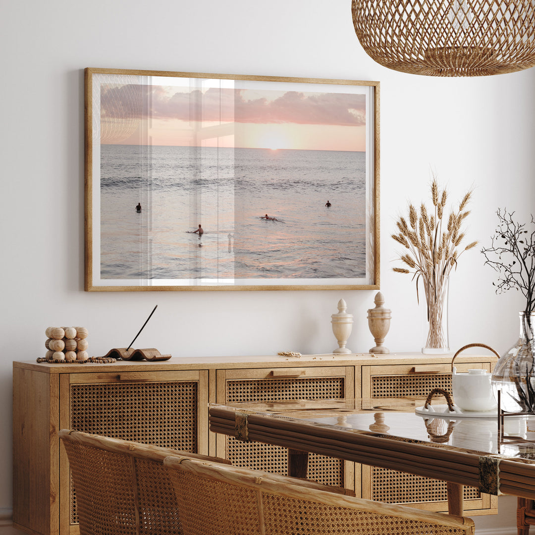 Surfers Waiting at Sunset, Costa Rica framed print hanging in a styled interior