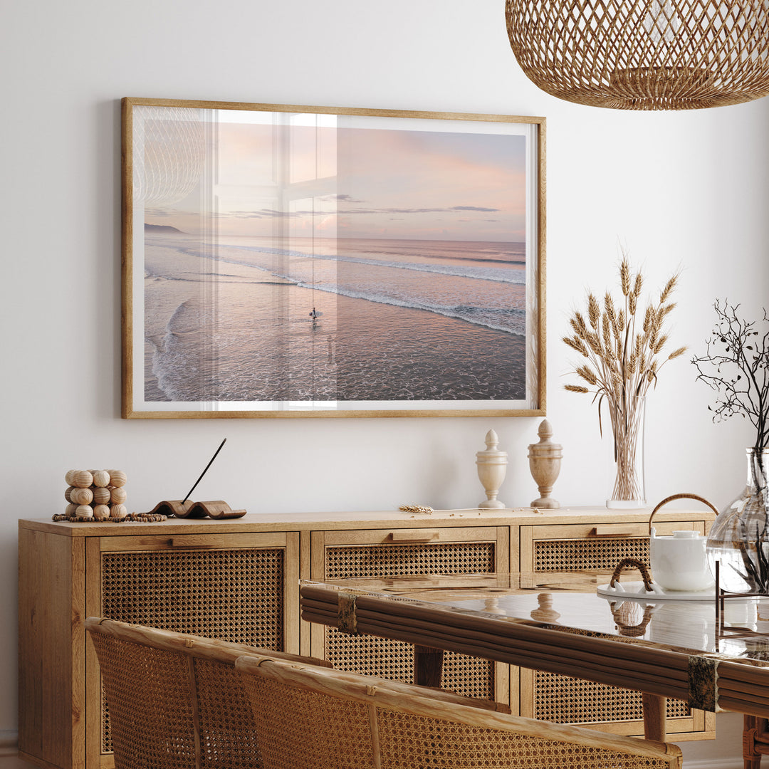 Lone Surfer on a Pink Beach II, Costa Rica framed print hanging in a styled interior
