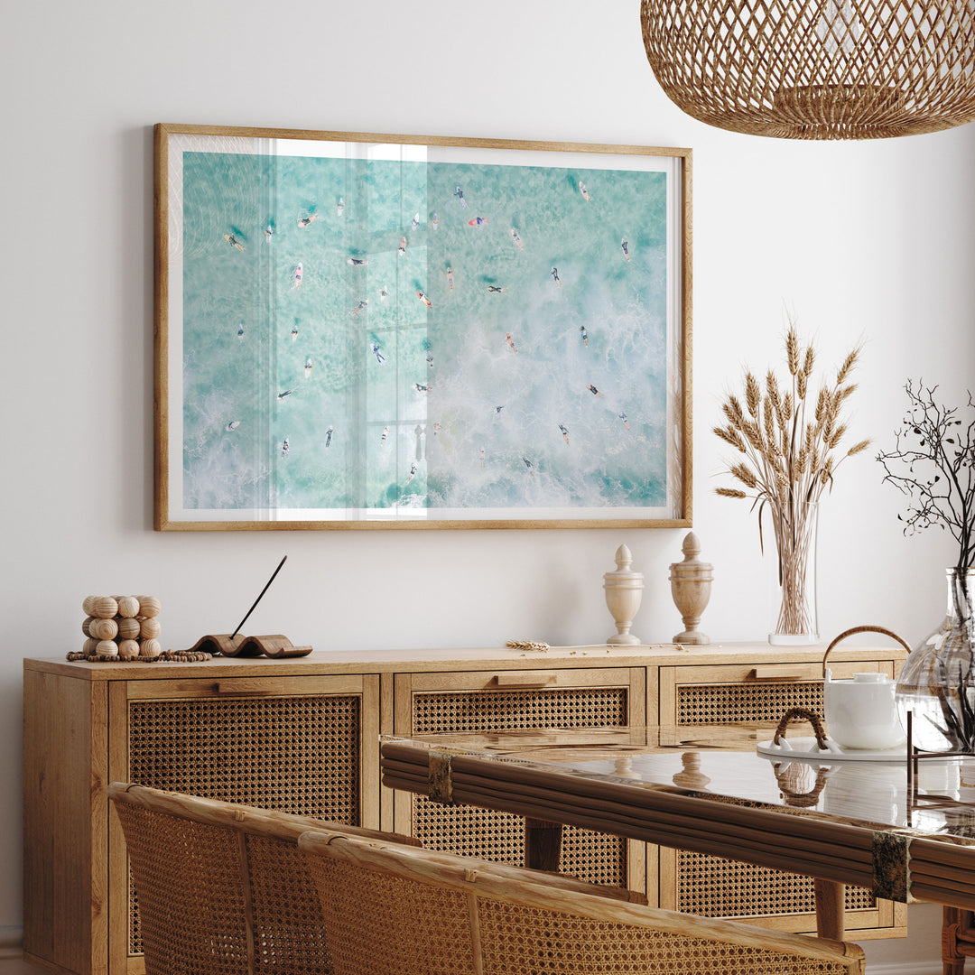 Framed Bondi Beach surfers print above a sideboard