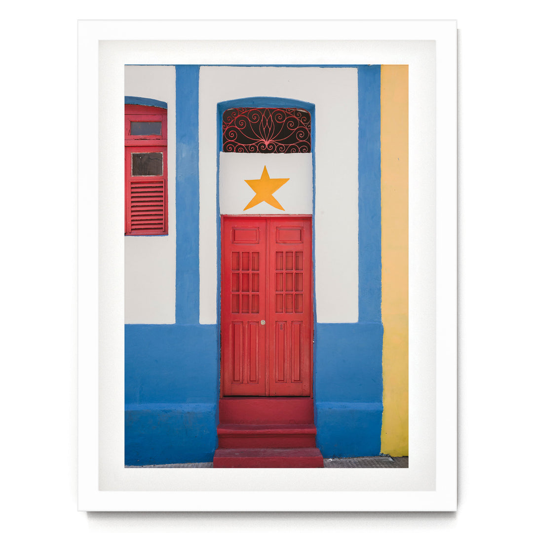 Red Door with Yellow Star, Olinda, Brazil print in a white frame with white mat